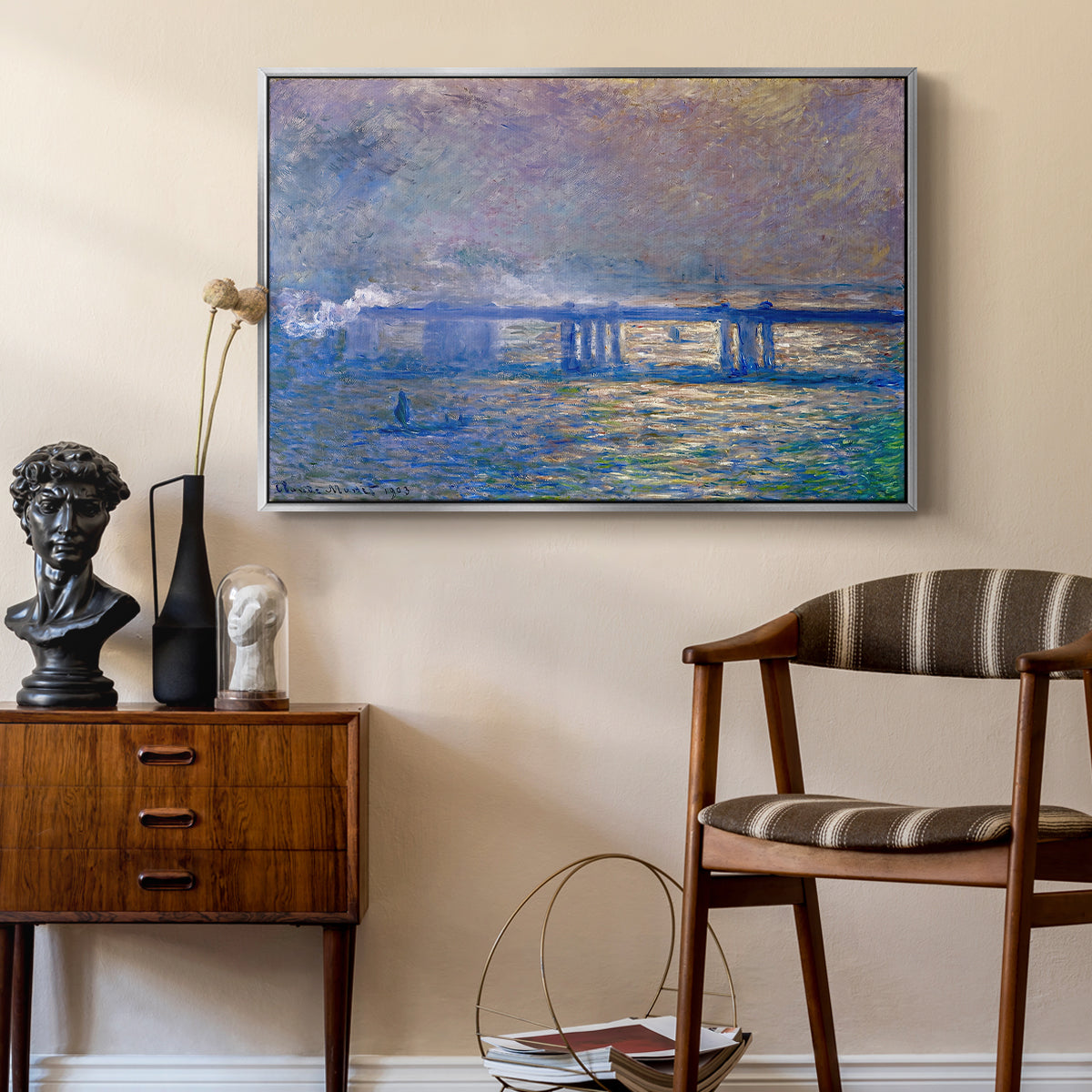 Charing Cross Bridge, 1903 by Claude Monet as a silver floater framed canvas featuring an atmospheric depiction of London bridge with reflections in water, styled above a mid-century console in a contemporary living area.