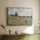 Silver floater framed canvas of The Poppy Field near Argenteuil, 1873 by Claude Monet, featuring an impressionist countryside scene with flowers and strolling figures above a sideboard in a softly lit hallway.