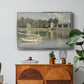 The Bridge at Argenteuil, 1874 by Claude Monet in a silver floater framed canvas featuring a bridge spanning river with sailboats and reflections in water, displayed above a wood console cabinet.