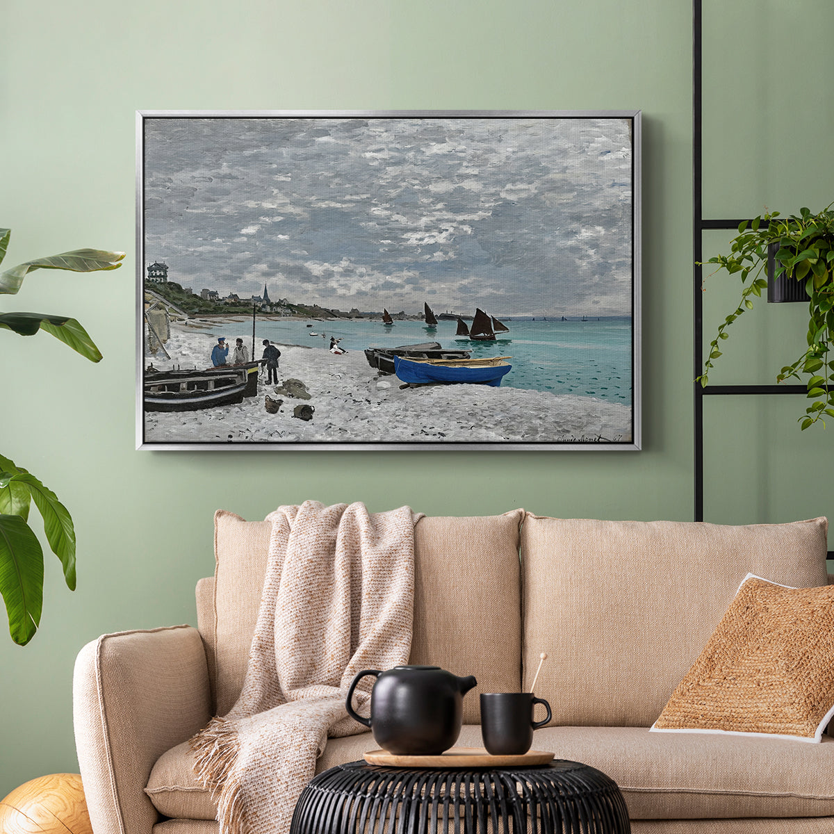 Silver floater framed canvas featuring an impressionist seaside gathering with flags and ocean view, displayed above a sofa in a modern living room.