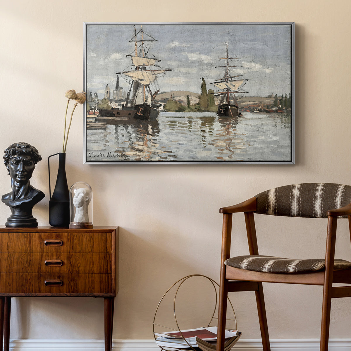 Ships Riding on the Seine at Rouen, 1872 by Claude Monet as a silver floater framed canvas featuring a harbor view with tall ships lining the waterfront in muted tones, styled above a mid-century console in a contemporary living area.