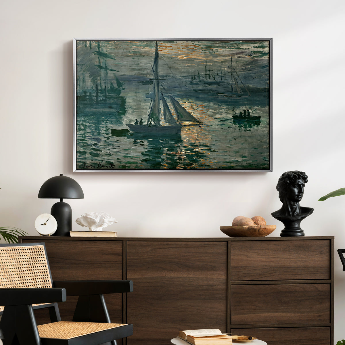 Sunrise (Marine), 1873 by Claude Monet displayed in a silver floater framed canvas above a dark wood credenza in an entryway.