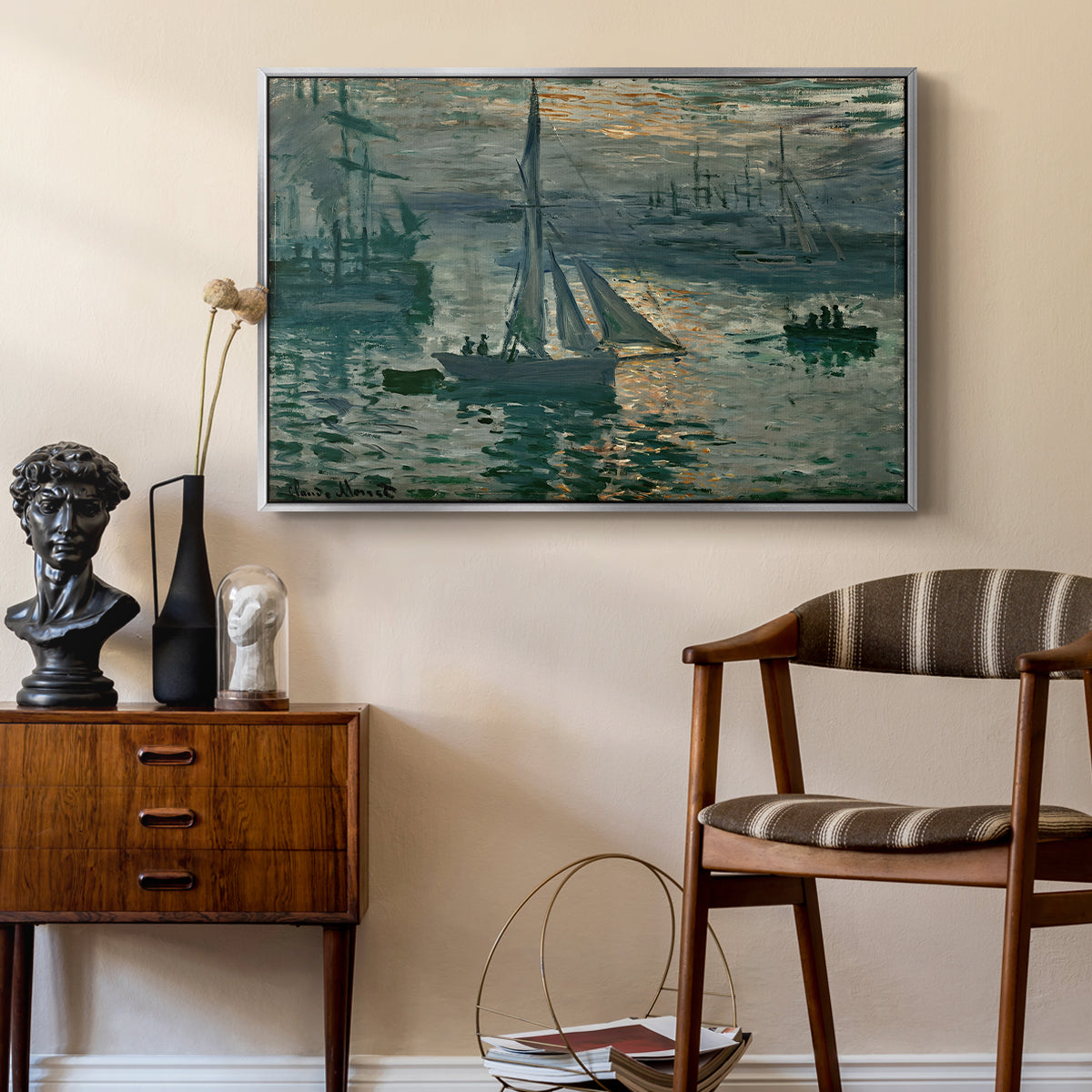Sunrise (Marine), 1873 by Claude Monet as a silver floater framed canvas featuring an early morning harbor scene with boats and diffused light, styled above a mid-century console in a contemporary living area.
