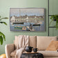Silver floater framed canvas featuring a tranquil river setting with sailboats and shoreline, displayed above a sofa in a modern living room.