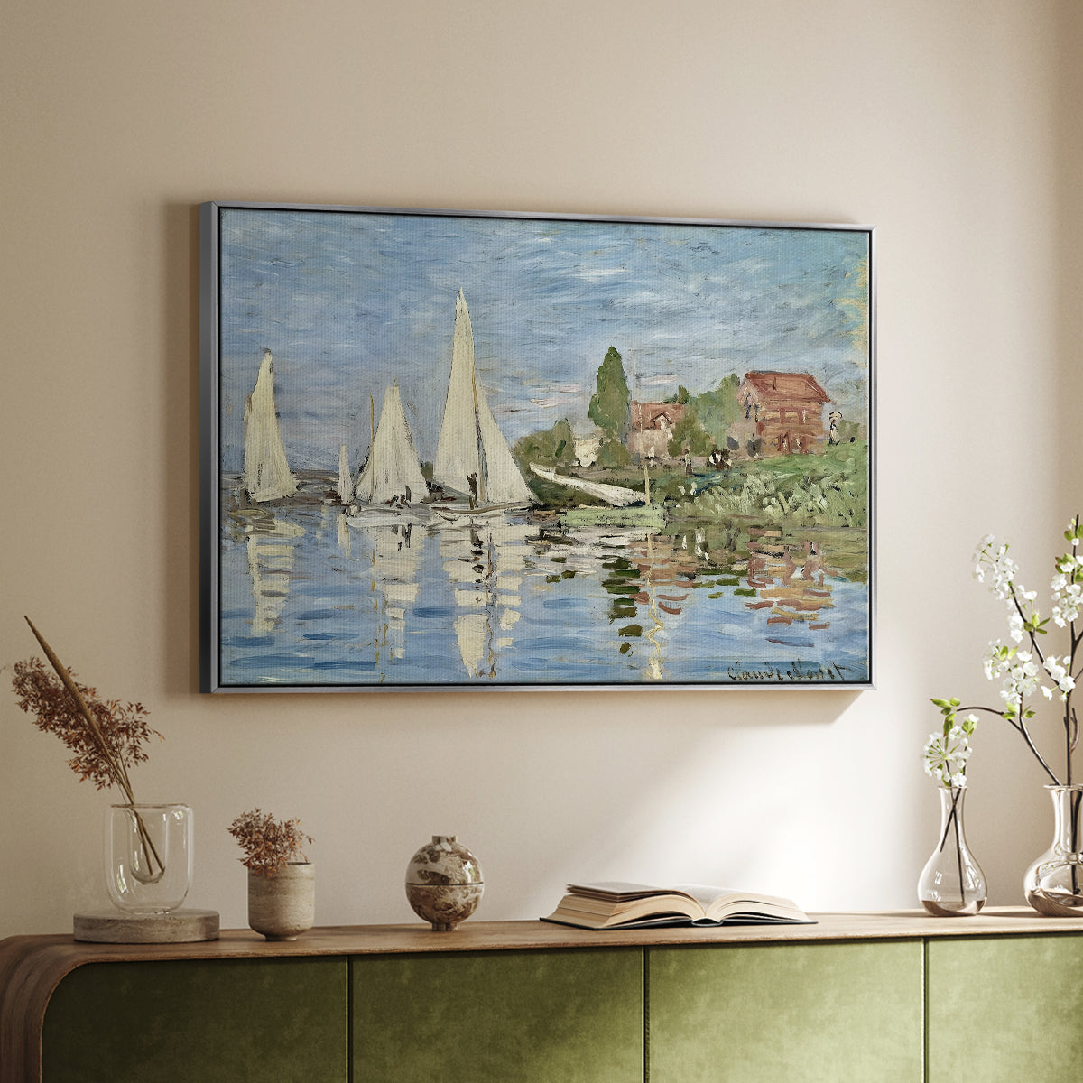 Silver floater framed canvas of Regatta at Argenteuil, 1872 by Claude Monet, featuring a lively regatta scene with multiple boats and fluttering sails above a sideboard in a softly lit hallway.