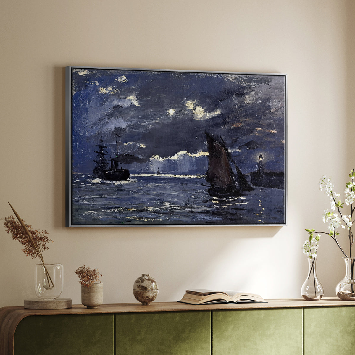 Silver floater framed canvas of A Seascape, Shipping by Moonlight, 1864 by Claude Monet, featuring a nocturnal seascape with boats silhouetted against glowing moon above a sideboard in a softly lit hallway.
