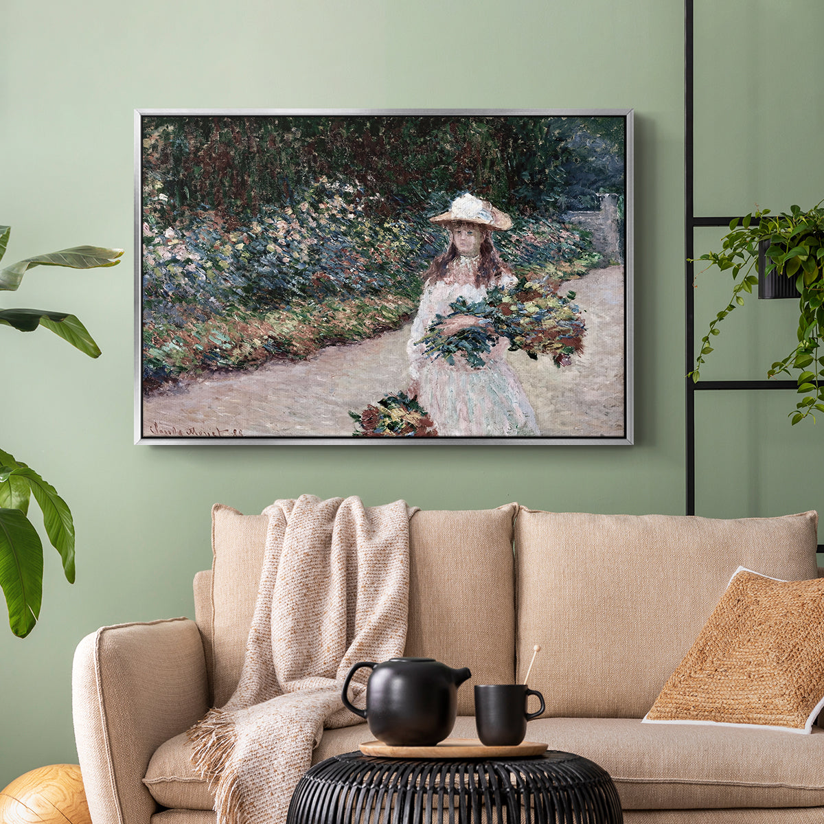 Silver floater framed canvas featuring a tranquil outdoor portrait of girl in floral setting, displayed above a sofa in a modern living room.