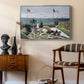 Garden at Sainte-Adresse, 1867 by Claude Monet as a silver floater framed canvas featuring a vibrant garden scene with colorful blooms and distant sea, styled above a mid-century console in a contemporary living area.
