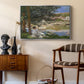 On the Bank of the Seine, Bennecourt, 1868 by Claude Monet as a silver floater framed canvas featuring an impressionist landscape with people relaxing along the Seine, styled above a mid-century console in a contemporary living area.