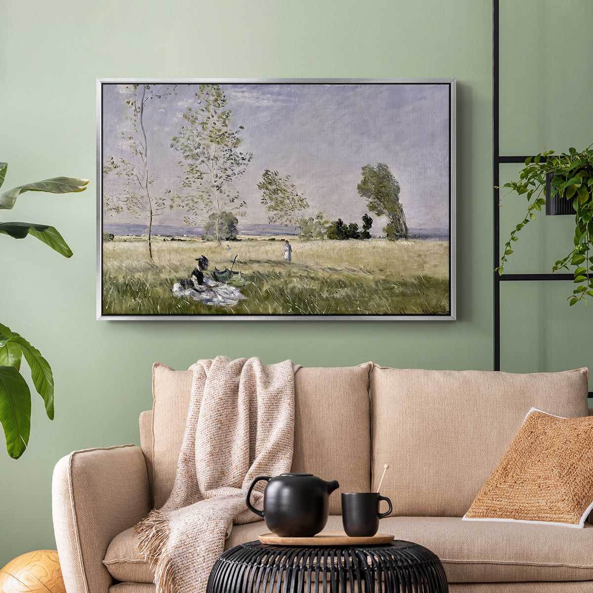 Silver floater framed canvas featuring a tranquil summer landscape with lone figure in nature, displayed above a sofa in a modern living room.