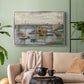 Silver floater framed canvas featuring a subdued urban landscape with structure spanning river, displayed above a sofa in a modern living room.