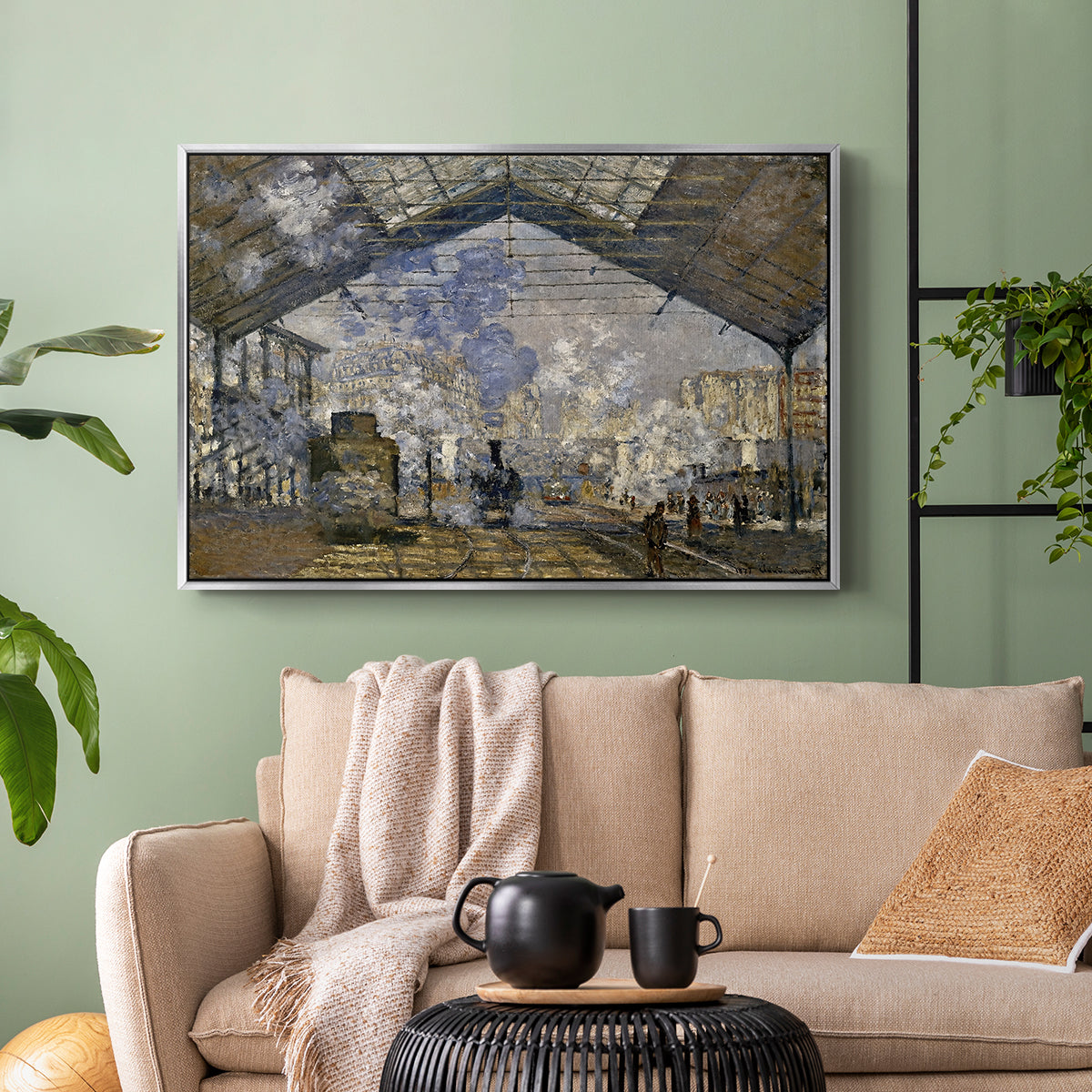 Silver floater framed canvas featuring a bustling transport hub with trains beneath glass roof, displayed above a sofa in a modern living room.