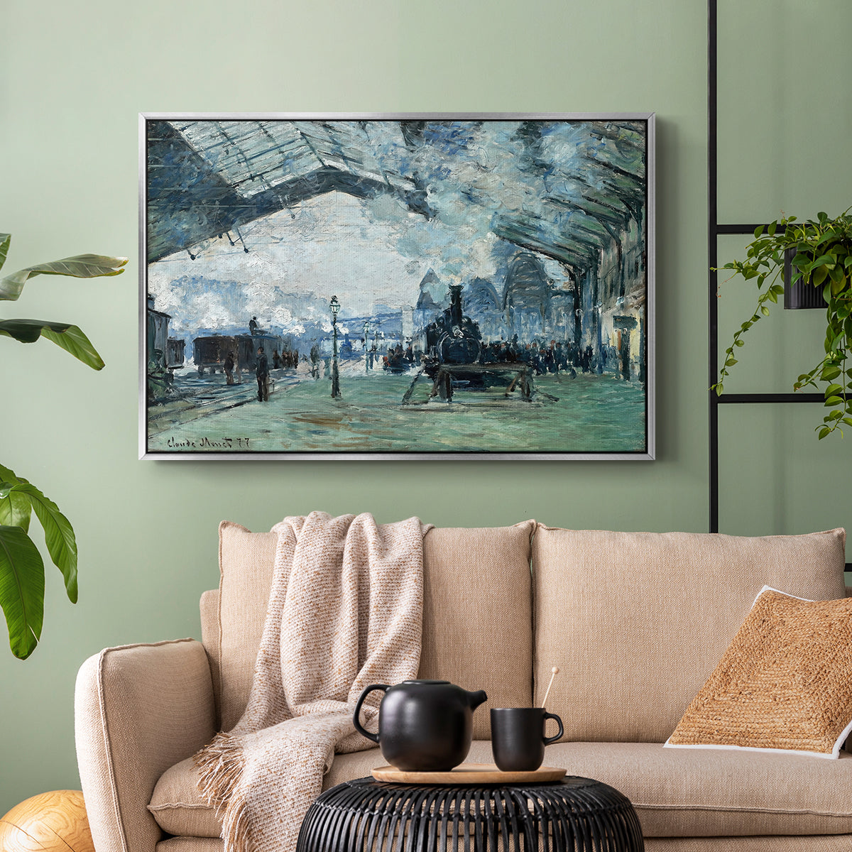 Silver floater framed canvas featuring a dramatic depiction of industrial space with trains and light, displayed above a sofa in a modern living room.