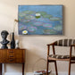 Water Lilies (Nymphéas), 1897-1899 by Claude Monet as a silver floater framed canvas featuring a tranquil water surface covered with blooming lilies, styled above a mid-century console in a contemporary living area.