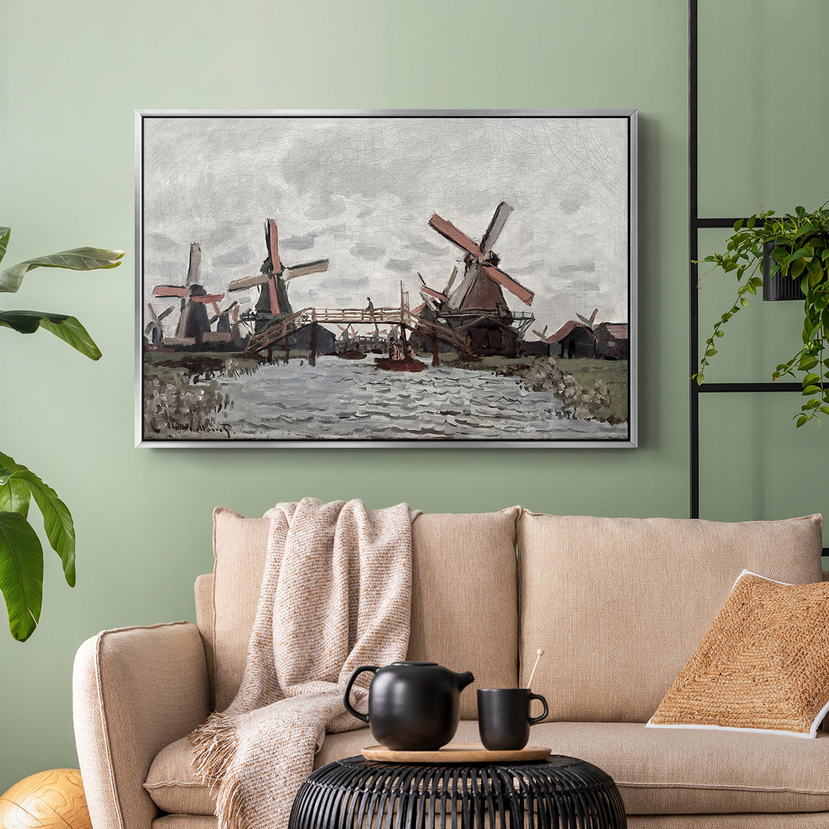 Silver floater framed canvas featuring a landscape featuring windmills and low horizon sky, displayed above a sofa in a modern living room.