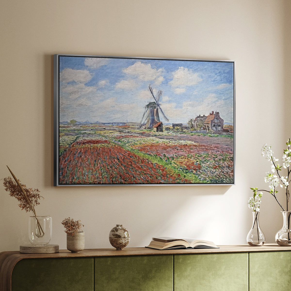 Silver floater framed canvas of Tulip Fields with the Rijnsburg Windmill, 1886 by Claude Monet, featuring a vibrant agricultural landscape with flowers and windmill above a sideboard in a softly lit hallway.