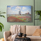 Silver floater framed canvas featuring a rural scene with patterned rows of flowers and windmill, displayed above a sofa in a modern living room.