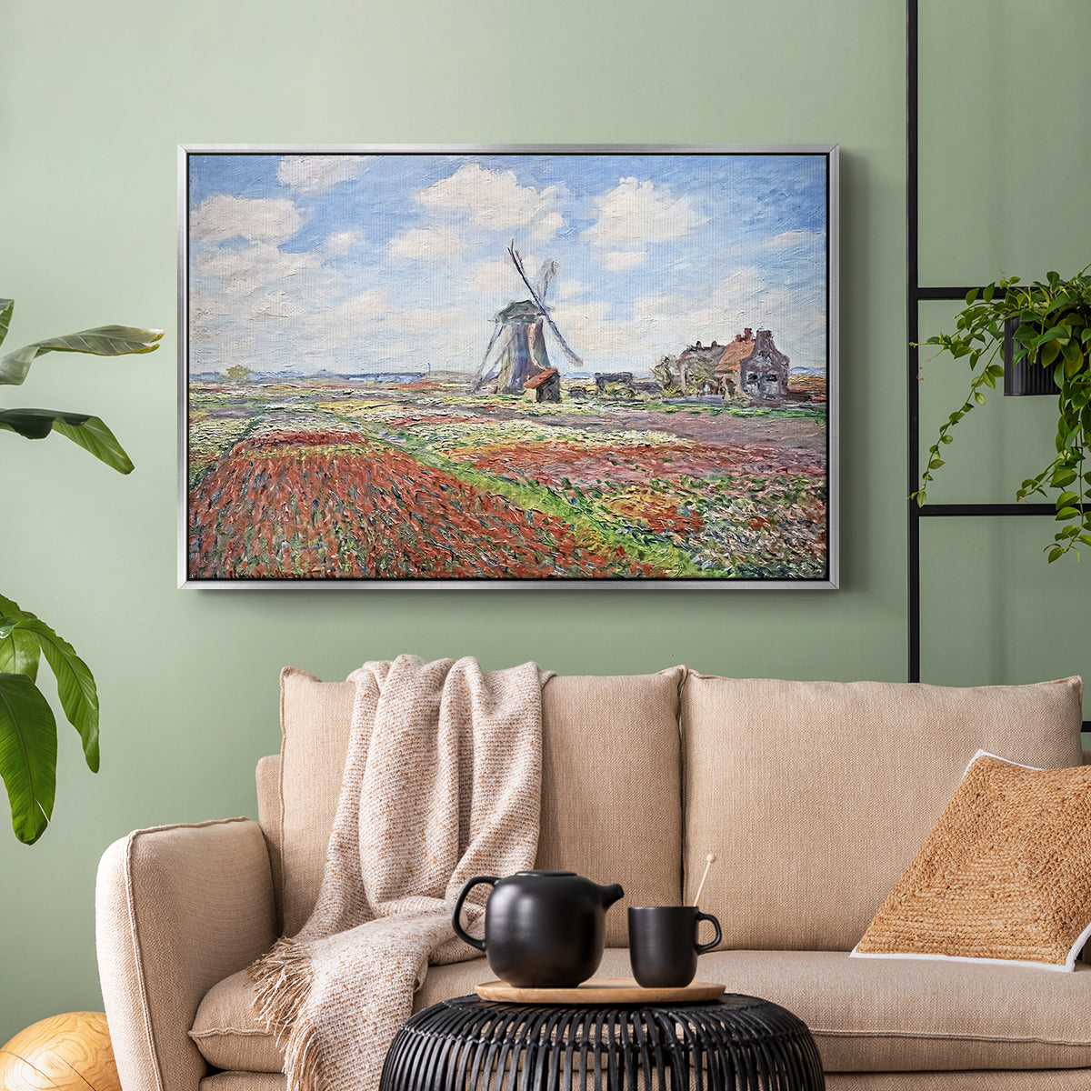 Silver floater framed canvas featuring a rural scene with patterned rows of flowers and windmill, displayed above a sofa in a modern living room.