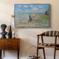 The Cliff Walk at Pourville, 1882 by Claude Monet as a silver floater framed canvas featuring a coastal cliff scene with grass, wind, and expansive sea view, styled above a mid-century console in a contemporary living area.