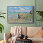 Silver floater framed canvas featuring an elevated shoreline path with figures and bright sky, displayed above a sofa in a modern living room.