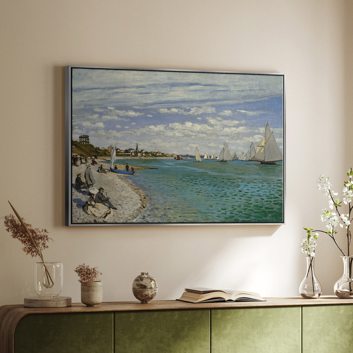 Silver floater framed canvas of Regatta at Sainte-Adresse, 1867 by Claude Monet, featuring a lively regatta scene with boats and people on beach above a sideboard in a softly lit hallway.