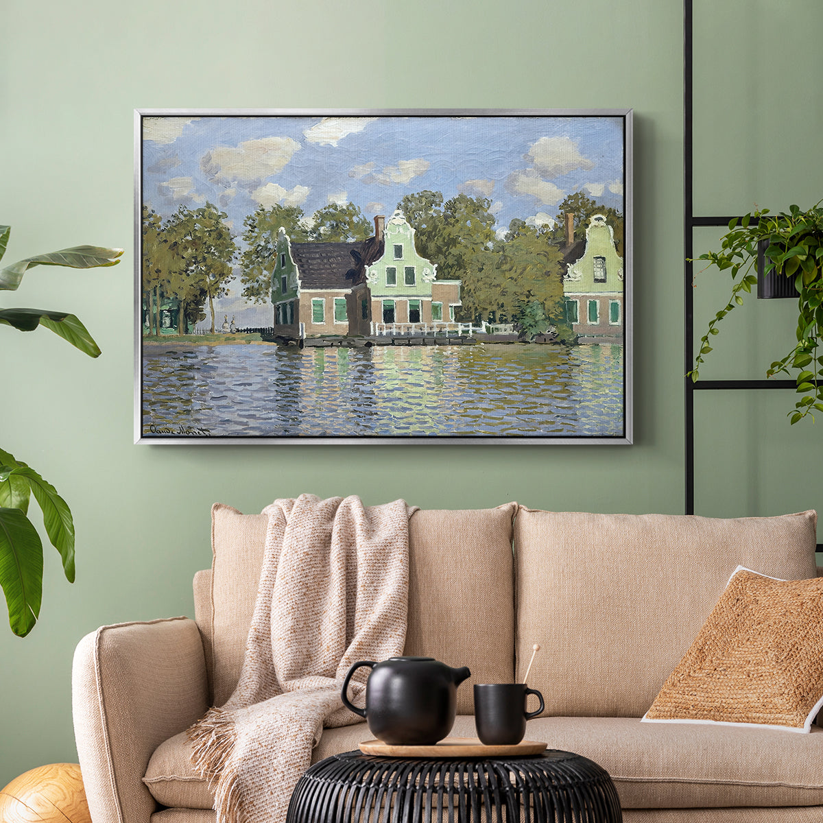 Silver floater framed canvas featuring a waterfront architecture with still reflections, displayed above a sofa in a modern living room.