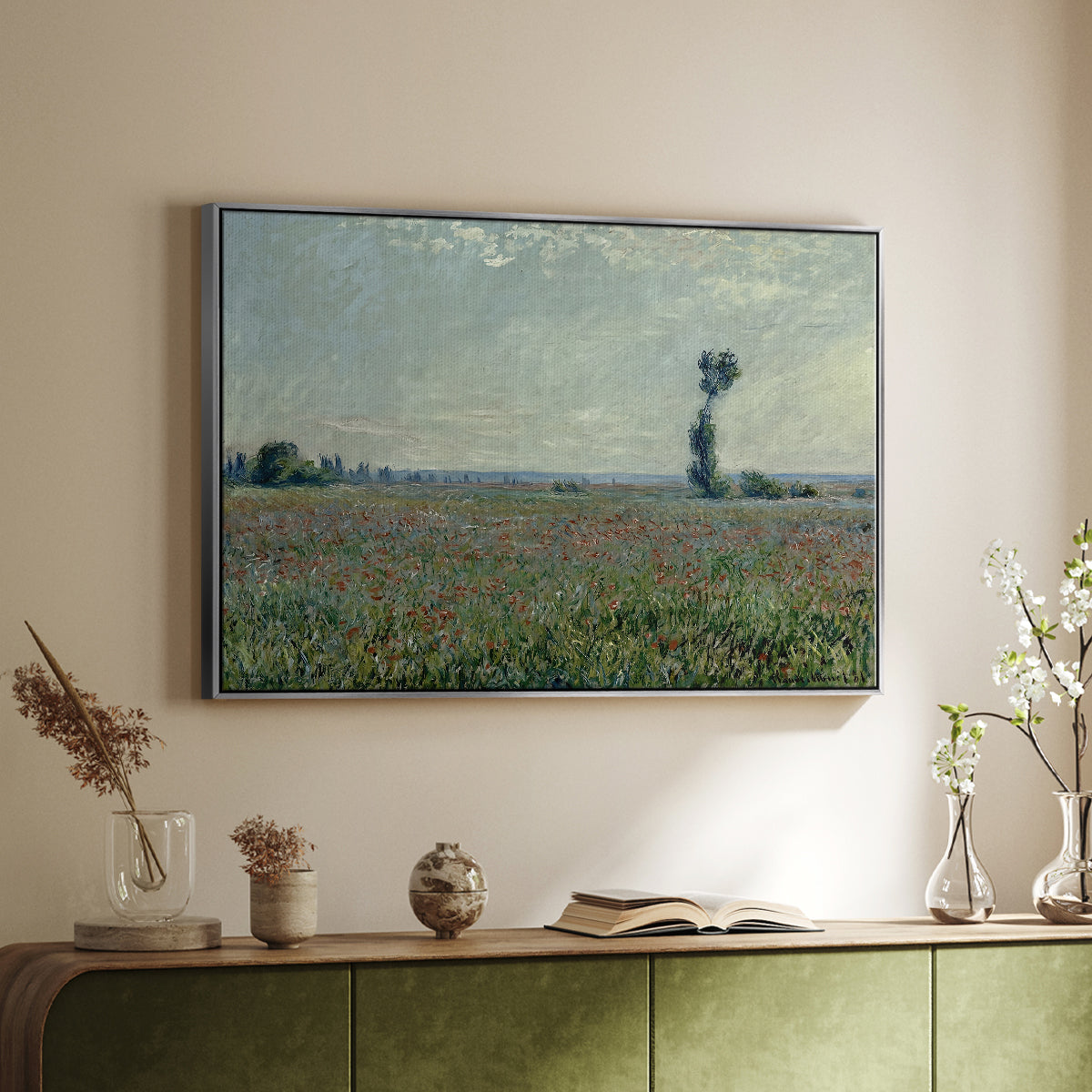 Silver floater framed canvas of Poppy Field, 1881 by Claude Monet, featuring an impressionist landscape filled with blooming flowers and greenery above a sideboard in a softly lit hallway.