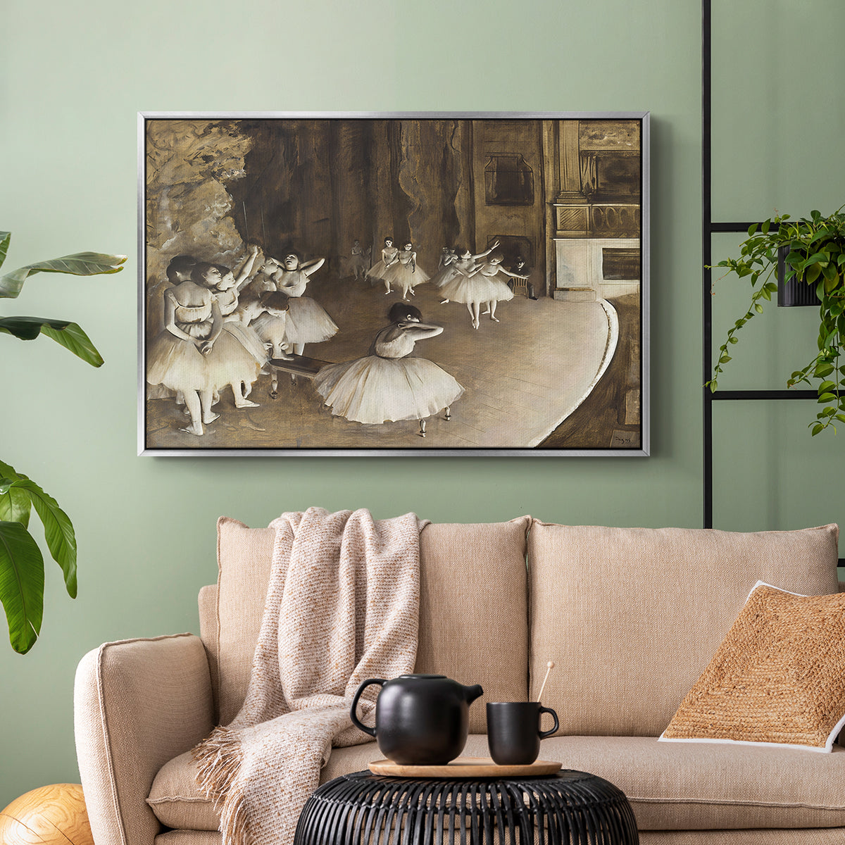 Silver floater framed canvas featuring dancers arranged on stage with visible set and depth, displayed above a sofa in a modern living room.