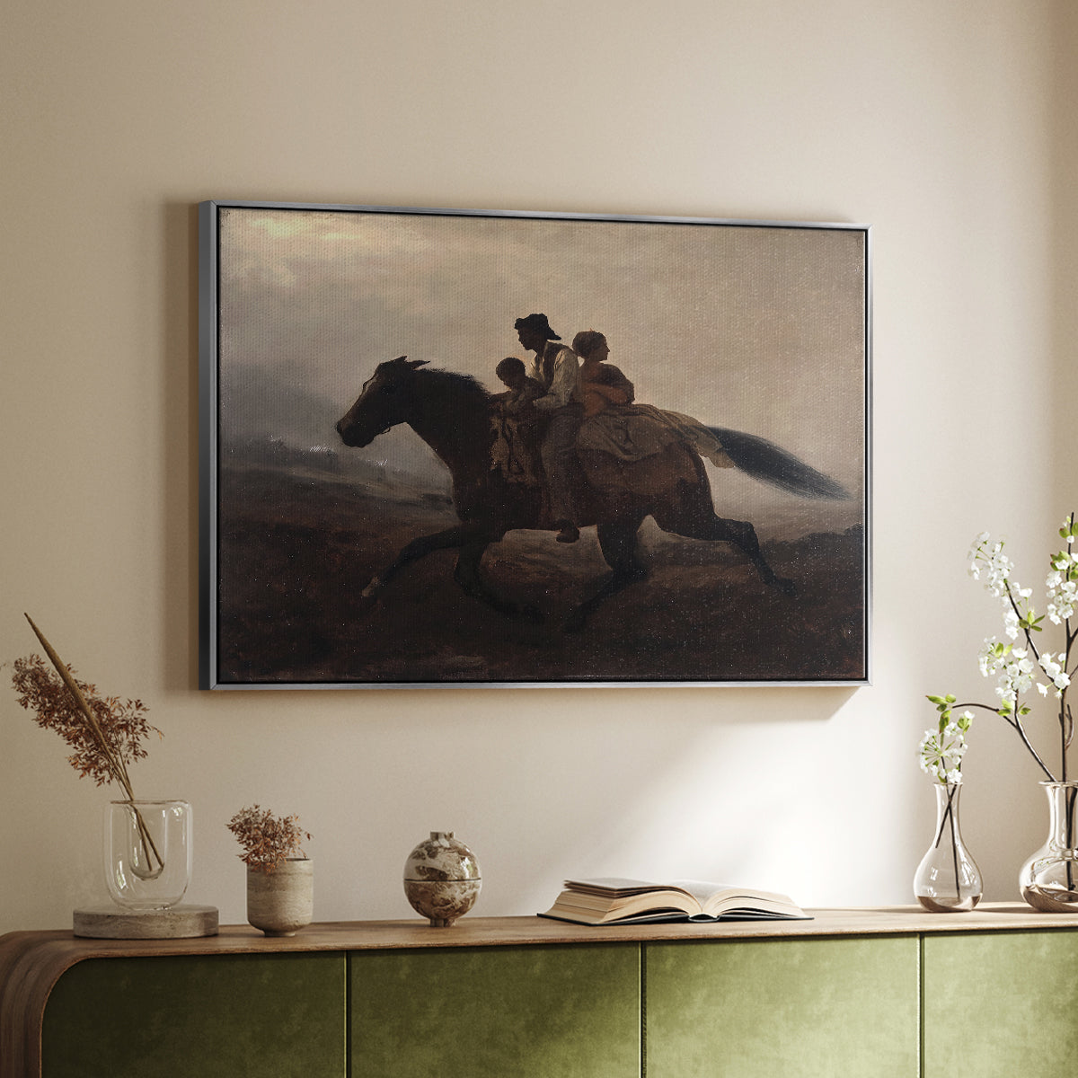 Silver floater framed canvas of A Ride for Liberty – The Fugitive Slaves, c. 1862 by Eastman Johnson, featuring a dramatic scene of enslaved people fleeing on horseback in darkness above a sideboard in a softly lit hallway.