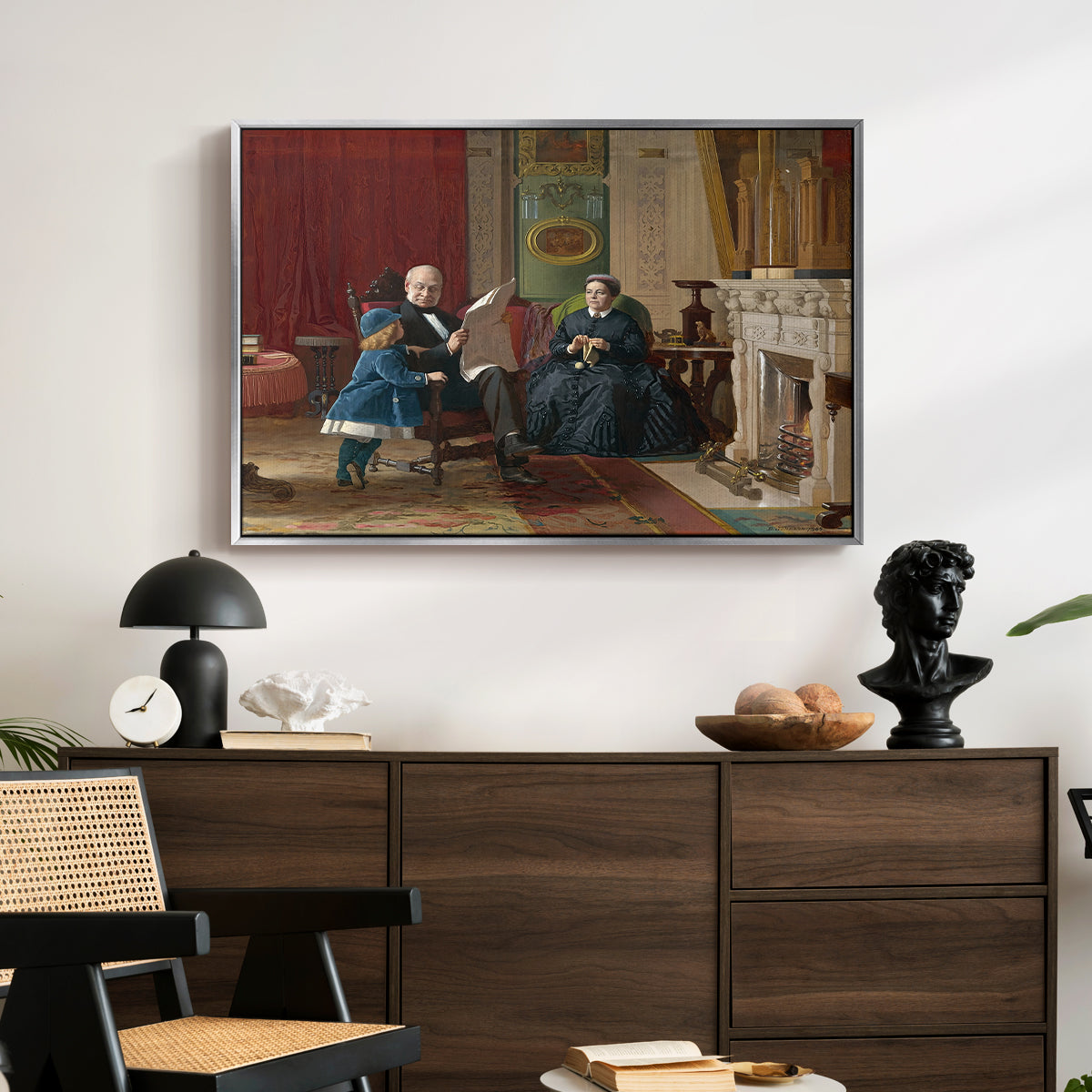 The Brown Family, 1869 by Eastman Johnson displayed in a silver floater framed canvas above a dark wood credenza in an entryway.