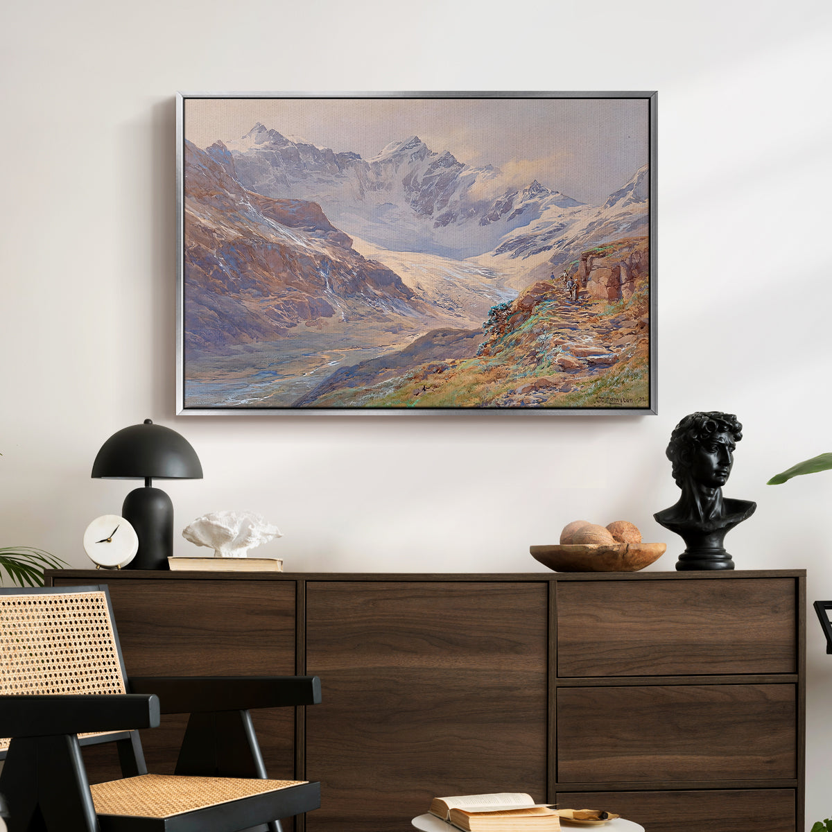 Odenwinklkees with the Johannisberg, 1902 by Edward Theodore Compton displayed in a silver floater framed canvas above a dark wood credenza in an entryway.