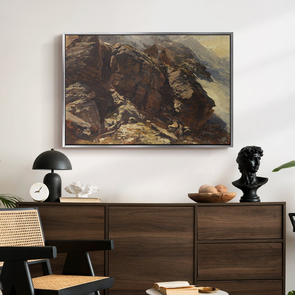 High Mountain Study, c. 1870 by Edward Theodore Compton displayed in a silver floater framed canvas above a dark wood credenza in an entryway.