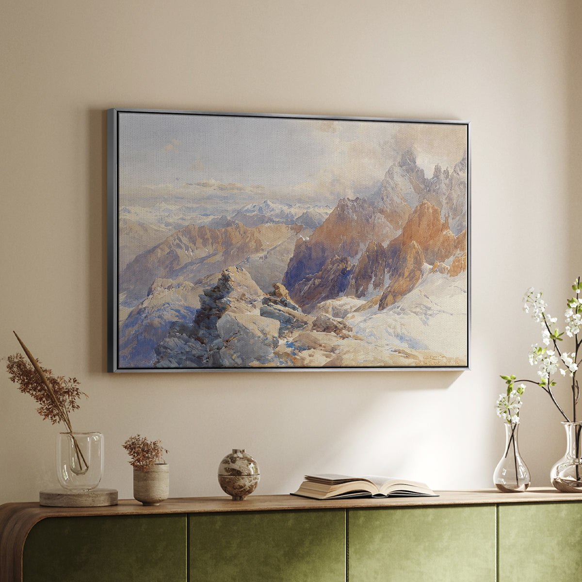 Silver floater framed canvas of Col du Géant, 1903 by Edward Theodore Compton, featuring a high mountain landscape featuring dramatic ridges and glacier terrain above a sideboard in a softly lit hallway.