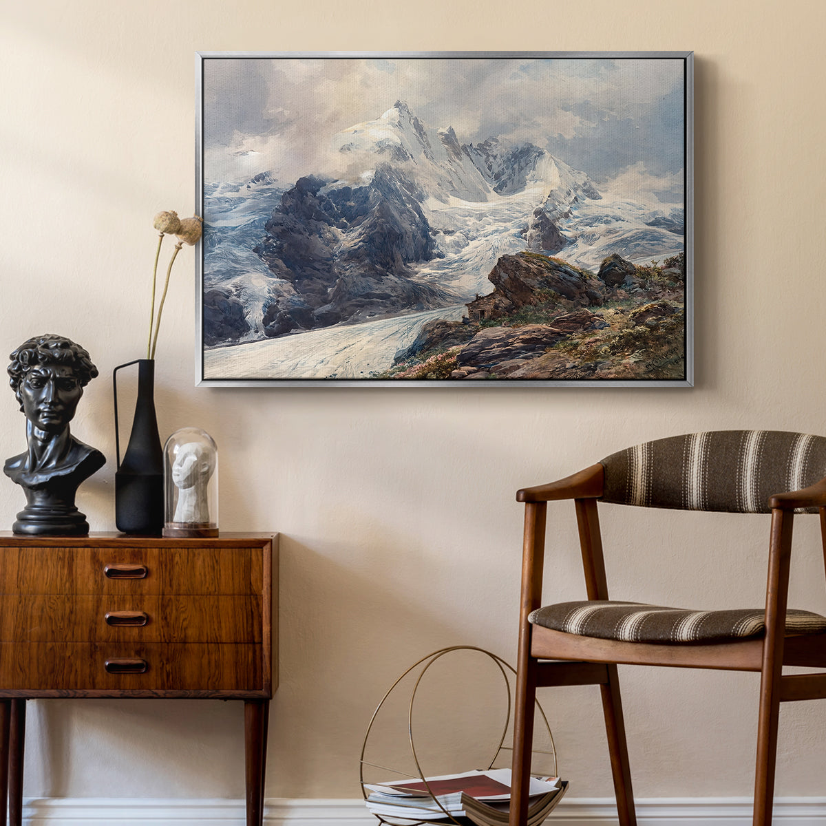 The Grossglockner, 1880 by Edward Theodore Compton as a silver floater framed canvas featuring a realistic landscape of high mountain under open sky, styled above a mid-century console in a contemporary living area.