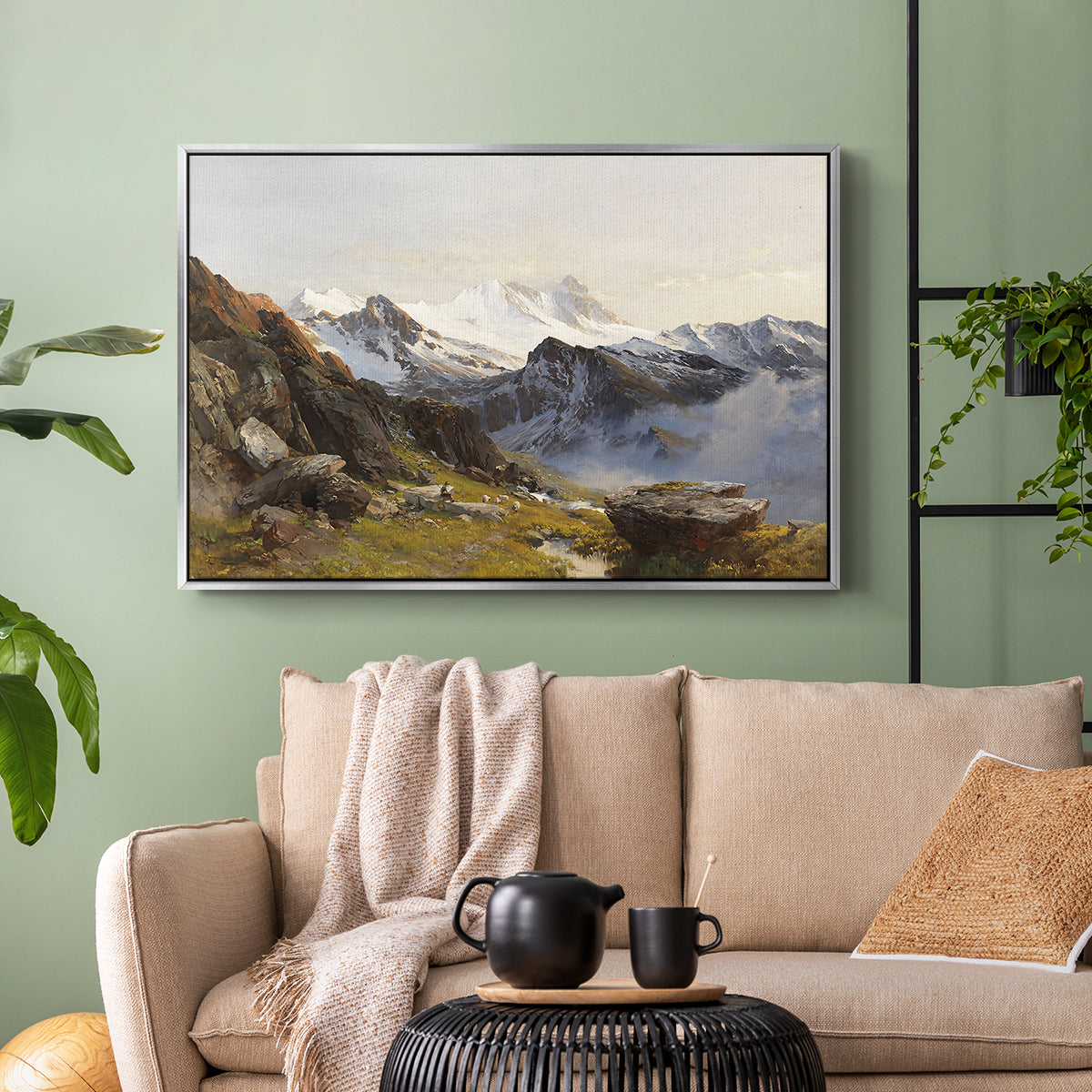 Silver floater framed canvas featuring a scenic mountain view with dramatic elevation and depth, displayed above a sofa in a modern living room.