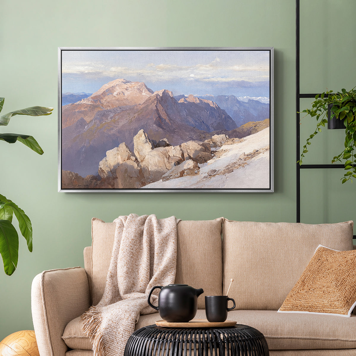 Silver floater framed canvas featuring an expansive mountainous landscape with natural depth, displayed above a sofa in a modern living room.