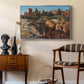 Palatine in Rome, c. 1921 by Edward Theodore Compton as a silver floater framed canvas featuring a cityscape with classical ruins and surrounding terrain, styled above a mid-century console in a contemporary living area.
