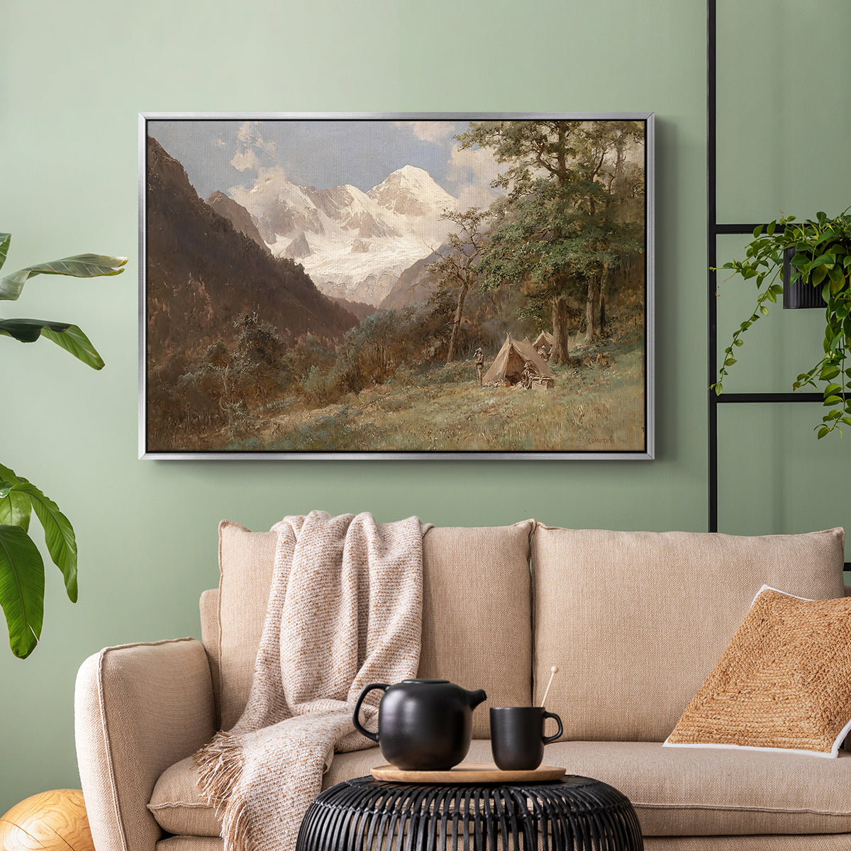 Silver floater framed canvas featuring a realistic depiction of remote mountain environment, displayed above a sofa in a modern living room.