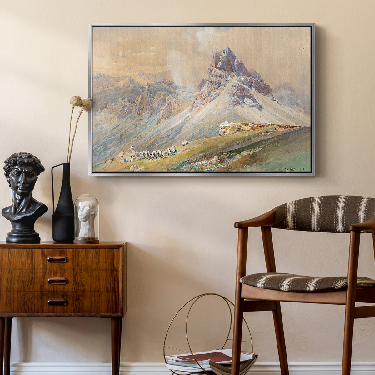 From the Dolomites, 1904 by Edward Theodore Compton as a silver floater framed canvas featuring an expansive landscape featuring iconic Dolomite peaks, styled above a mid-century console in a contemporary living area.