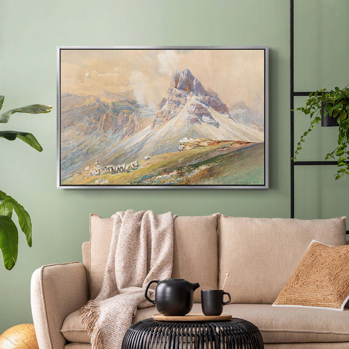 Silver floater framed canvas featuring a realistic mountain view with strong geological forms, displayed above a sofa in a modern living room.