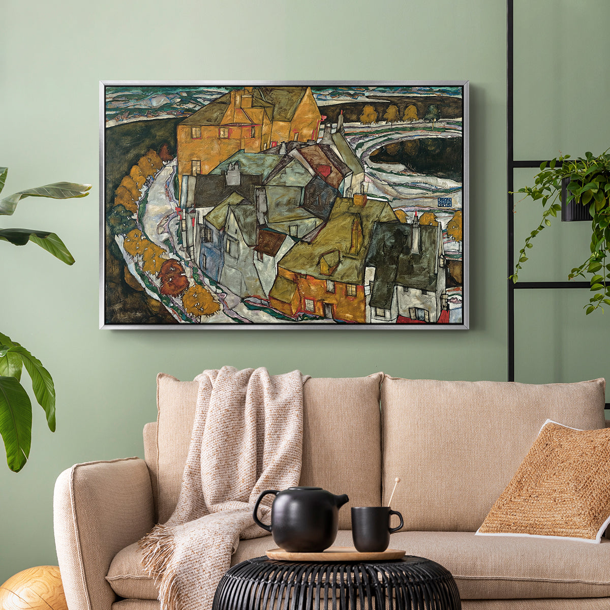 Silver floater framed canvas featuring an architectural scene with houses arranged in curved composition, displayed above a sofa in a modern living room.