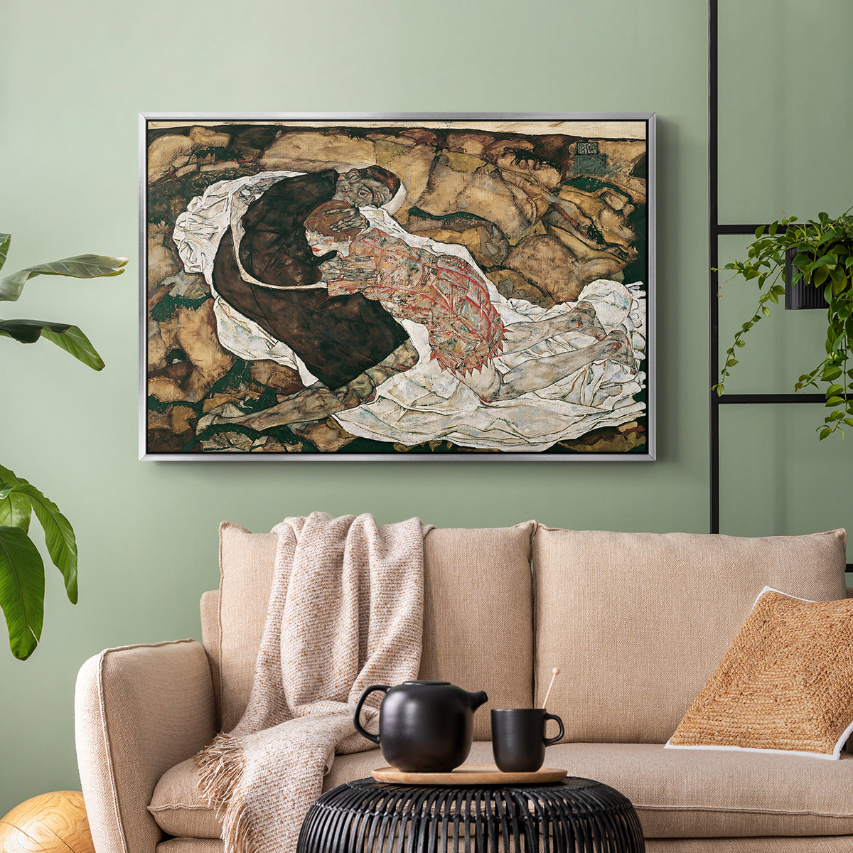 Silver floater framed canvas featuring an intense composition exploring life and death through figures, displayed above a sofa in a modern living room.