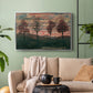 Silver floater framed canvas featuring an expressionist landscape featuring isolated trees in field, displayed above a sofa in a modern living room.
