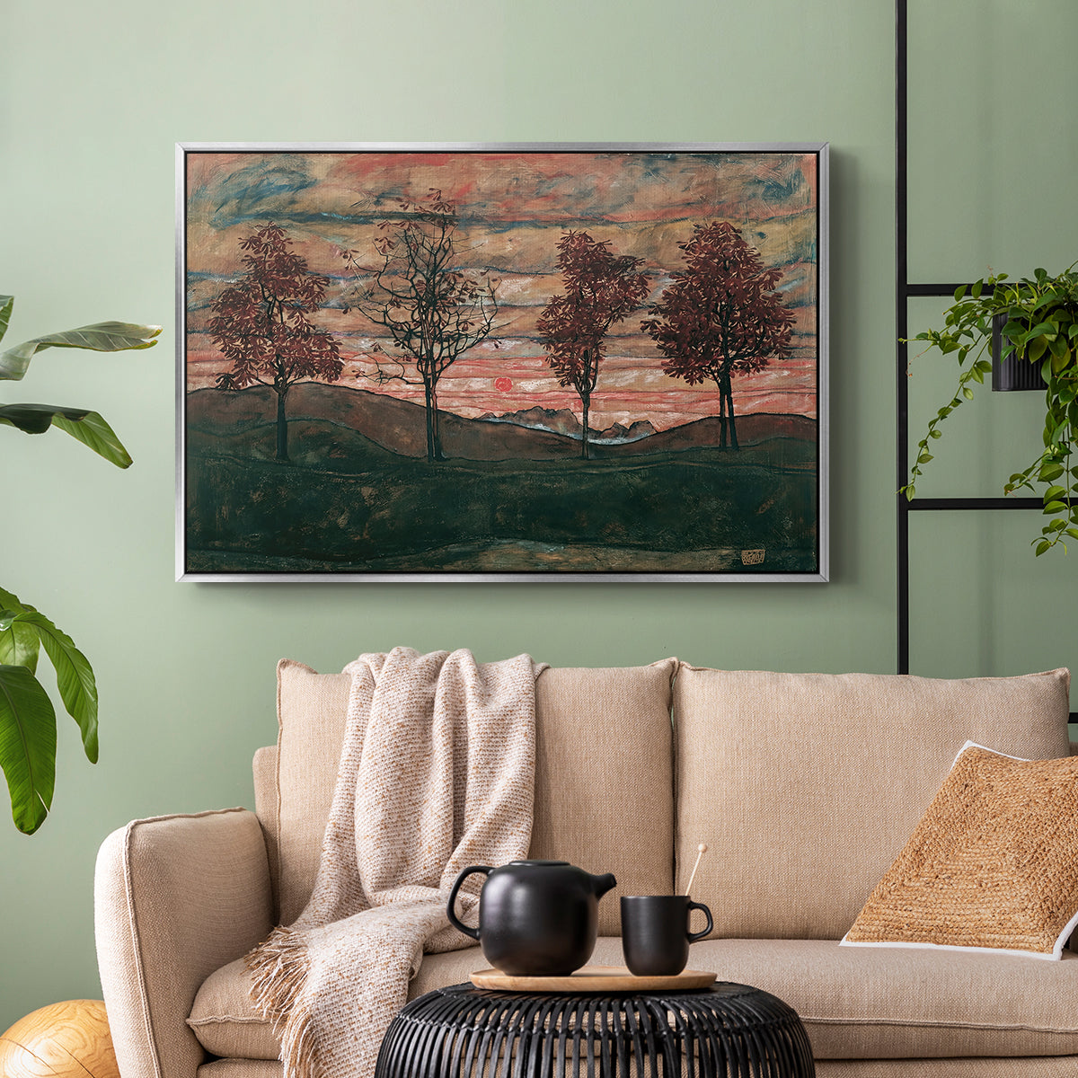 Silver floater framed canvas featuring an expressionist landscape featuring isolated trees in field, displayed above a sofa in a modern living room.
