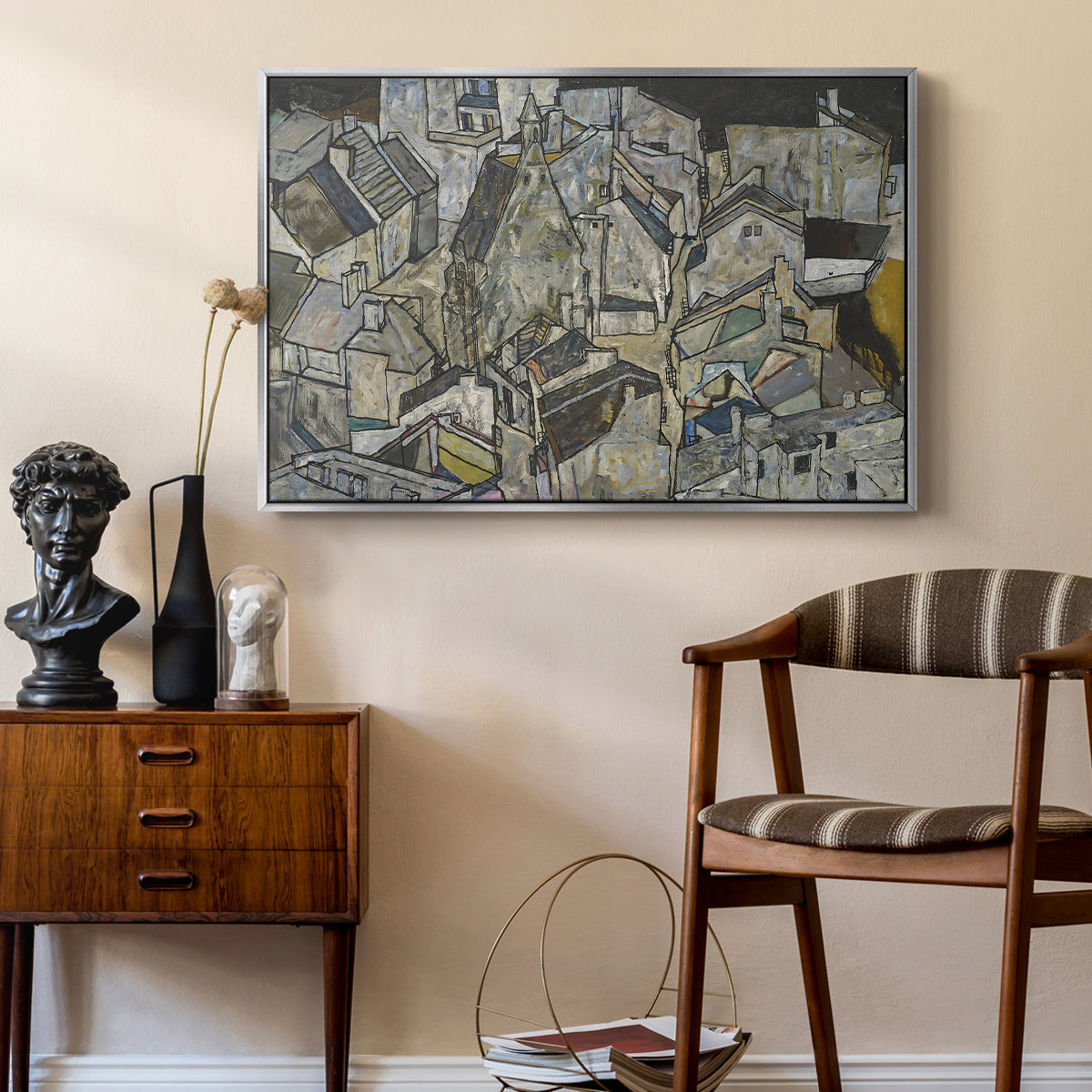 Mödling II, 1918 by Egon Schiele as a silver floater framed canvas featuring an abstracted town view with angular rooftops and fragmented forms, styled above a mid-century console in a contemporary living area.