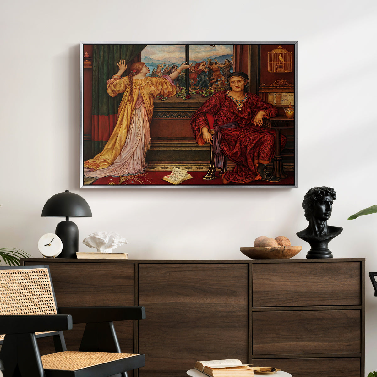The Gilded Cage, c. 1901-1902 by Evelyn De Morgan displayed in a silver floater framed canvas above a dark wood credenza in an entryway.
