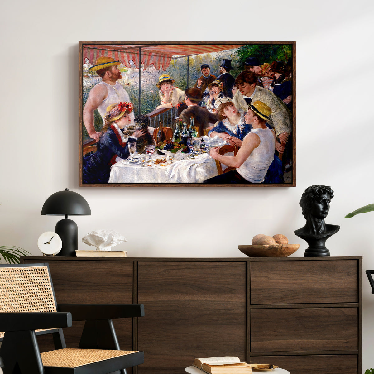 Luncheon of the Boating Party (Le Déjeuner des canotiers), 1880-1881 by Pierre-Auguste Renoir displayed in a walnut floater framed canvas above a dark wood credenza in an entryway.