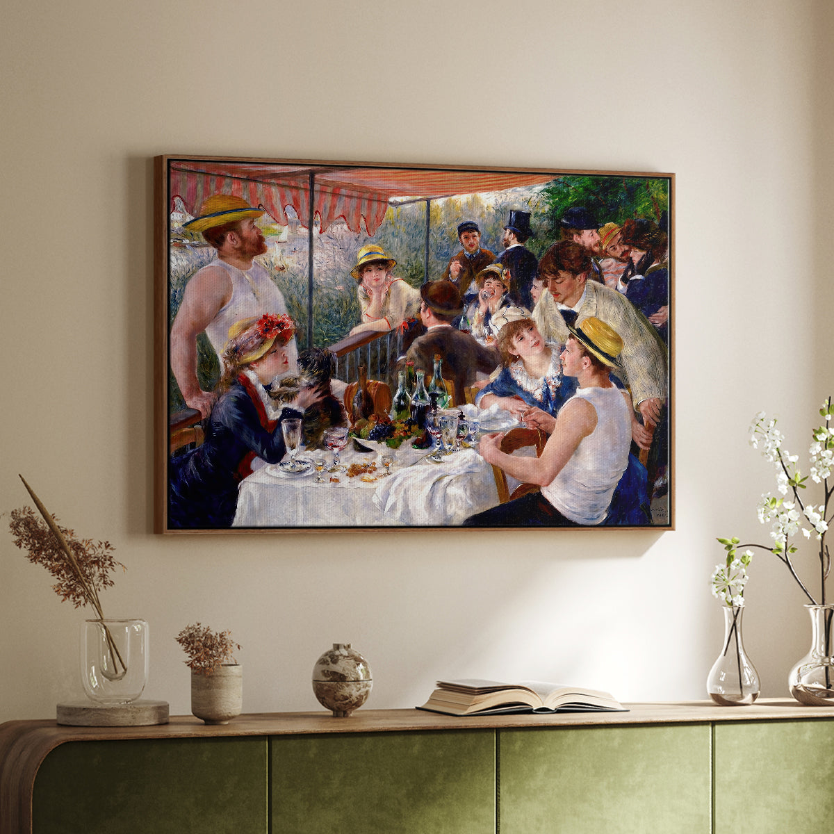 Walnut floater framed canvas of Luncheon of the Boating Party (Le Déjeuner des canotiers), 1880-1881 by Pierre-Auguste Renoir, featuring a lively gathering of men and women eating and socializing at outdoor table above a sideboard in a softly lit hallway.