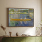 Walnut floater framed canvas of The Skiff (La Yole), 1875 by Pierre-Auguste Renoir, featuring an impressionist boating scene with people relaxing in a narrow skiff above a sideboard in a softly lit hallway.