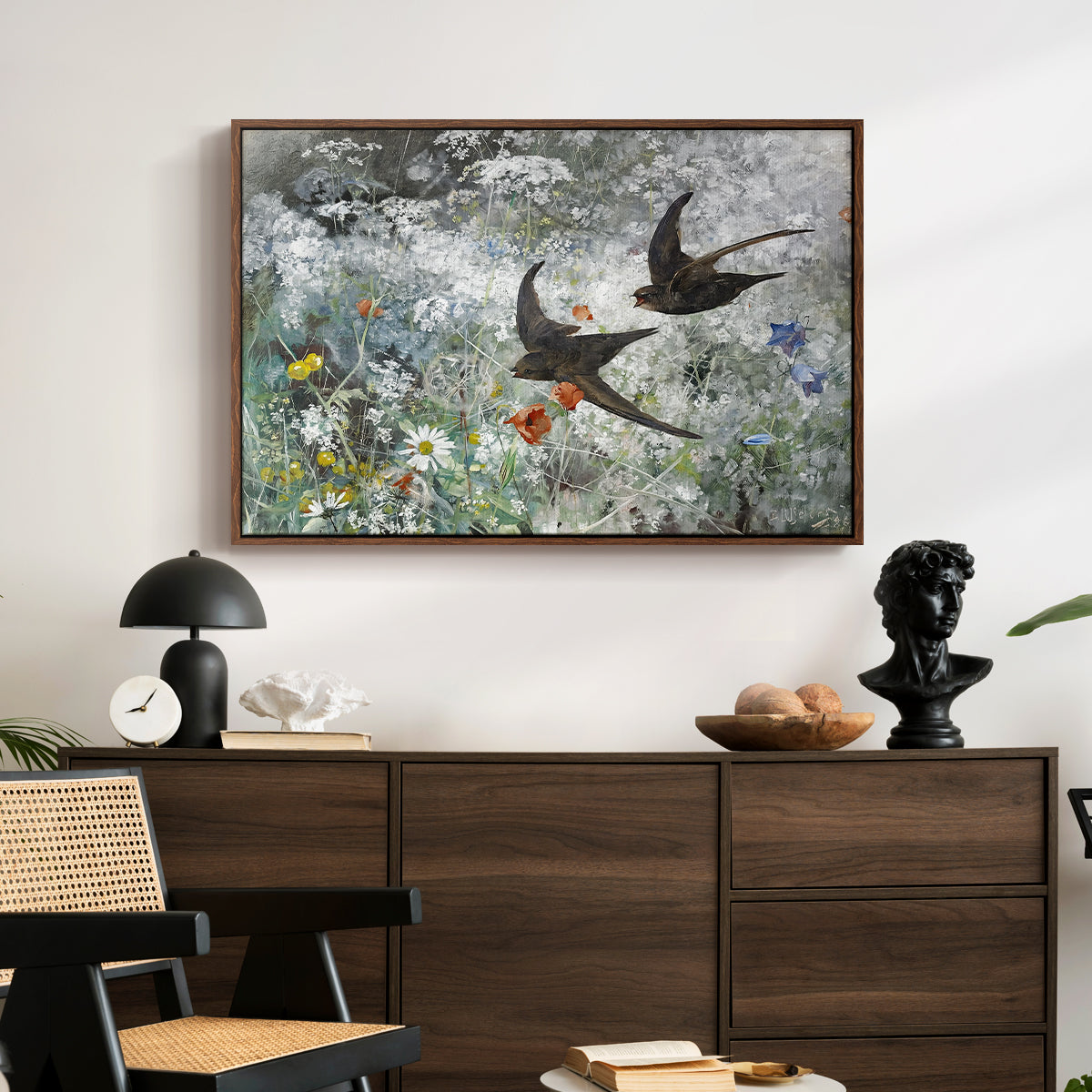 Common Swifts, 1886 by Bruno Liljefors displayed in a walnut floater framed canvas above a dark wood credenza in an entryway.